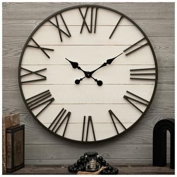 a large clock sitting on top of a wooden table