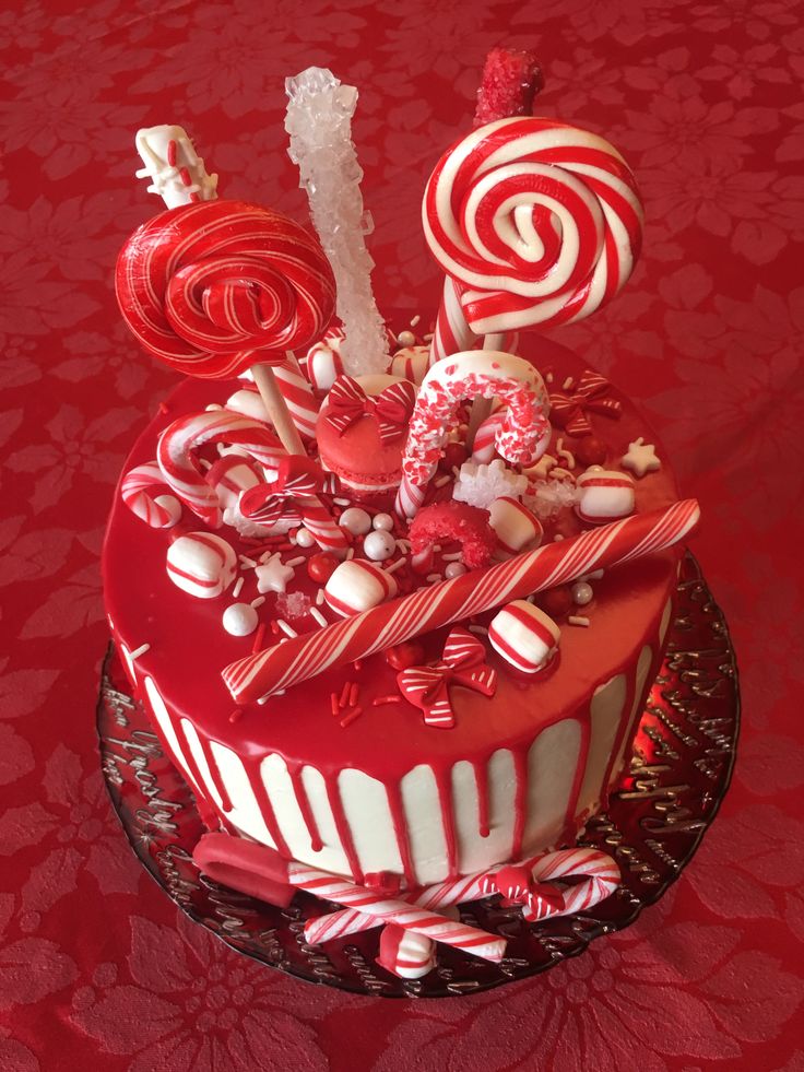 a red and white cake topped with lots of candy