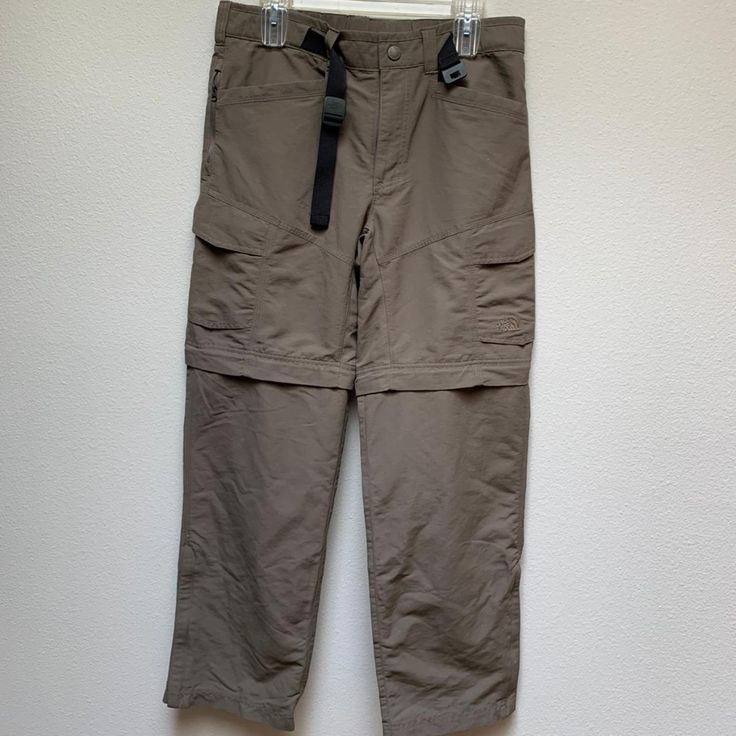 These Cargo Pants Are New Without Tags. They Include A Belt With North Face Printed On The Buckle. There Are Two Pockets Under The Belt Lined With Mesh, Two Pockets On The Side Of The Waist That Zip, Two On The Leg, And Two In The Back With Velcro. These Pants Also Have A Zipper So You Can Convert Them Into Cargo Shorts. 100% Nylon Leg: 39" Waist: 17" Hiking Trousers With Pockets, The North Face Hiking Pants With Pockets, Casual The North Face Bottoms For Outdoor Activities, Spring Outdoor Cargo Pants With Belt Loops, Spring Cargo Pants With Belt Loops For Outdoor, The North Face Cargo Pants With Pockets For Outdoor, The North Face Cargo Pants For Outdoor Activities, The North Face Casual Cargo Pants For Outdoor, Casual The North Face Cargo Pants For Outdoor