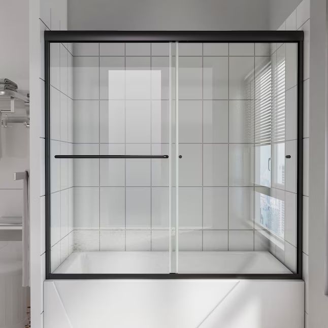 a white bathroom with a glass shower door