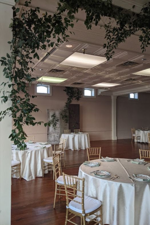 an empty room with tables and chairs set up for a formal dinner or banquet event