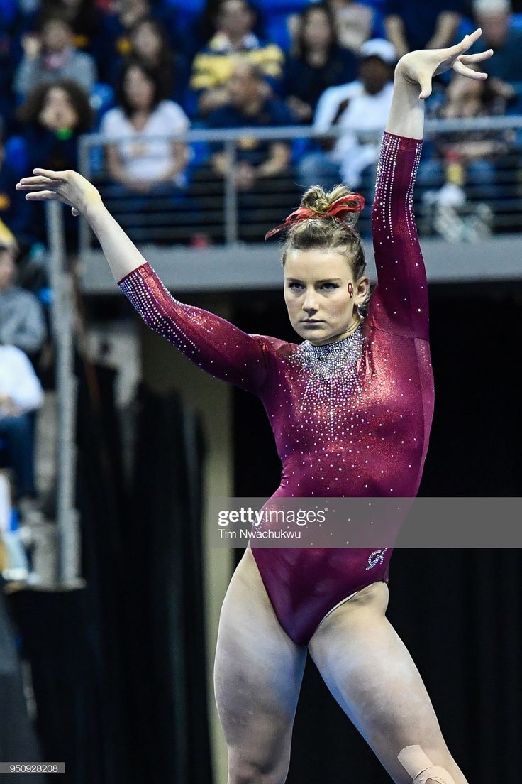 a female gymnastics player in action on the floor