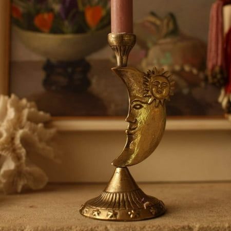 a gold candle holder sitting on top of a table