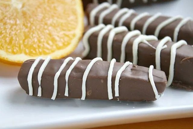 chocolate covered orange slices on a white plate