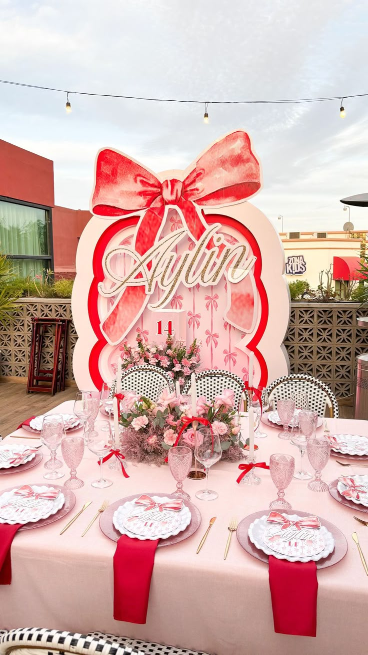 a table set up for an event with plates and napkins on top of it