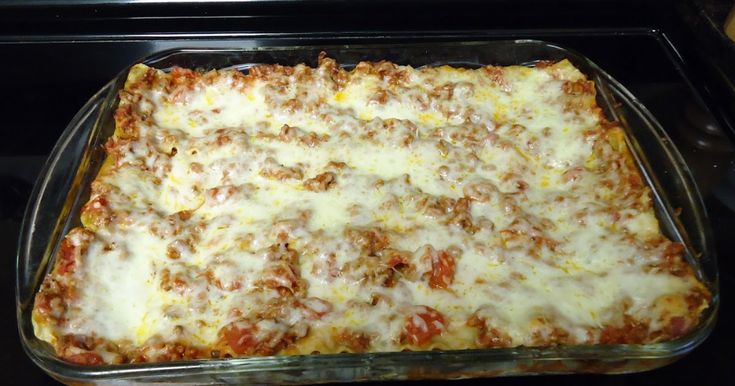 a casserole dish with meat and cheese in an oven