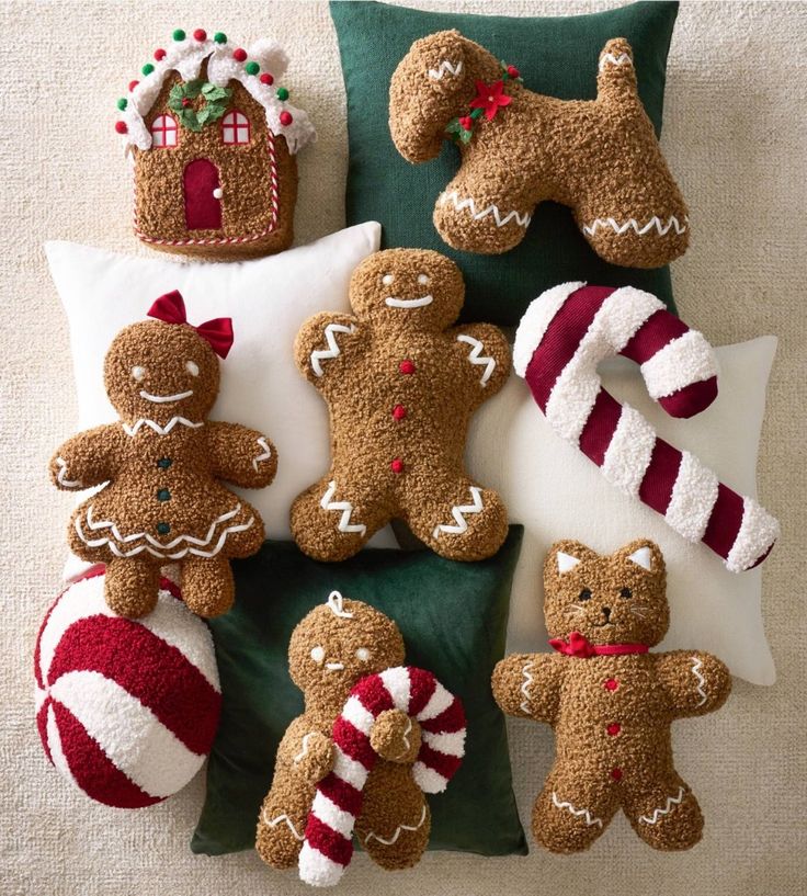 a group of stuffed gingerbread men and women sitting on top of a green pillow