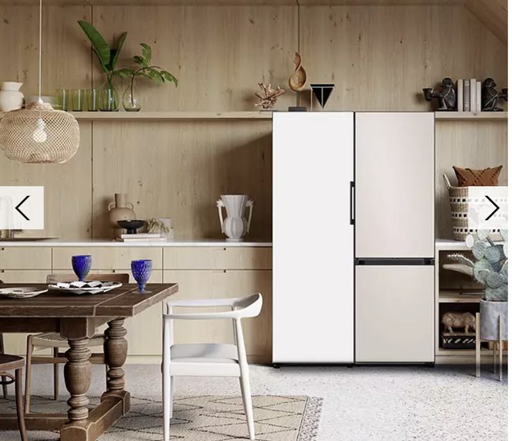 a white refrigerator freezer sitting inside of a kitchen next to a dining room table