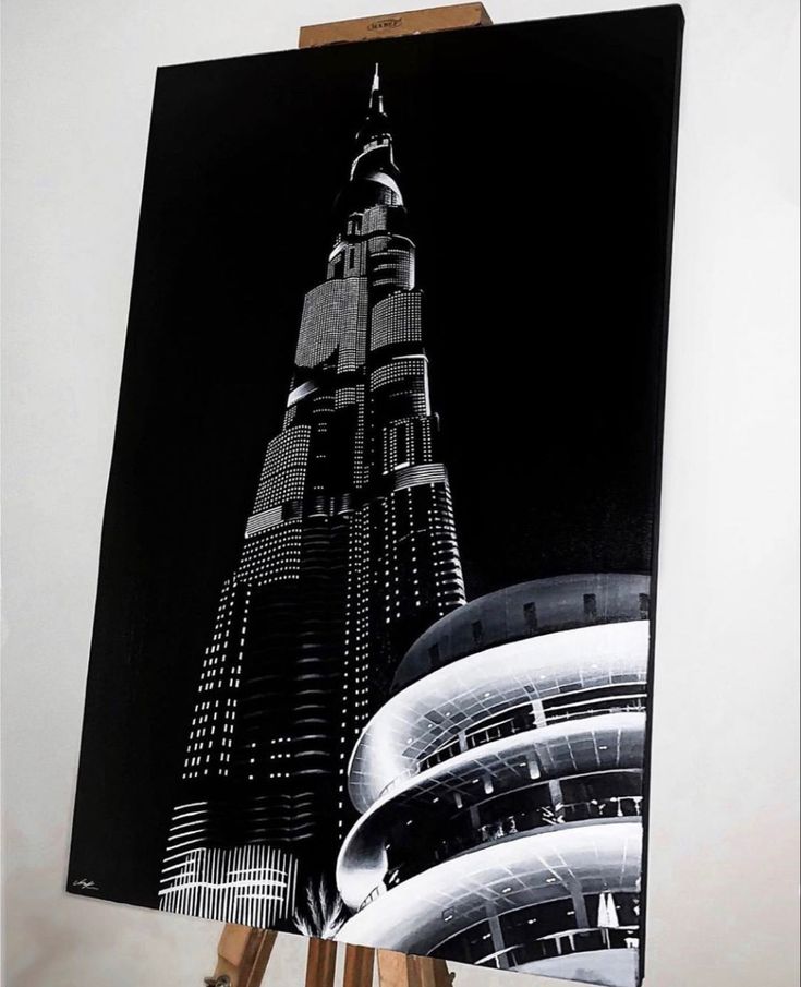 a black and white photo of a tall building in the middle of an art project