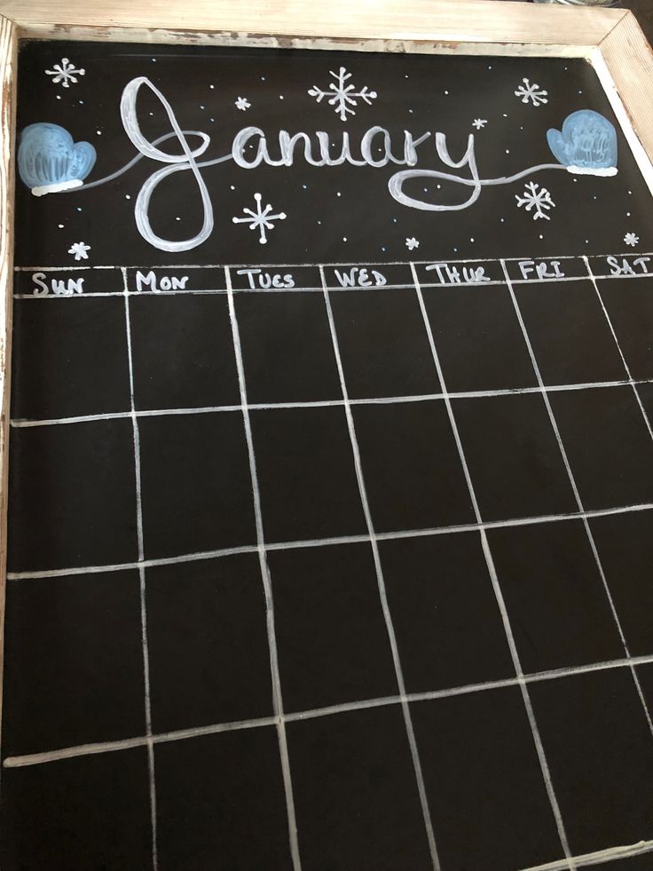 a chalk board with the word january written on it and snowflakes around it