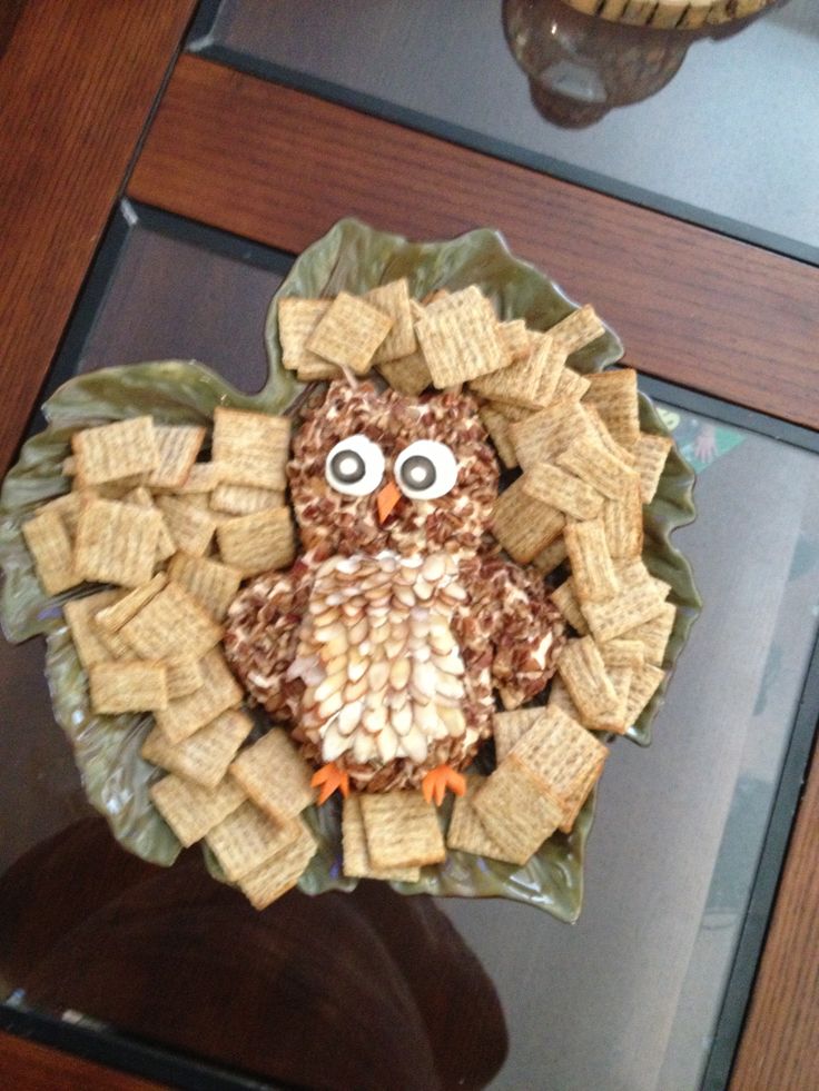 an owl made out of crackers sitting on top of a table