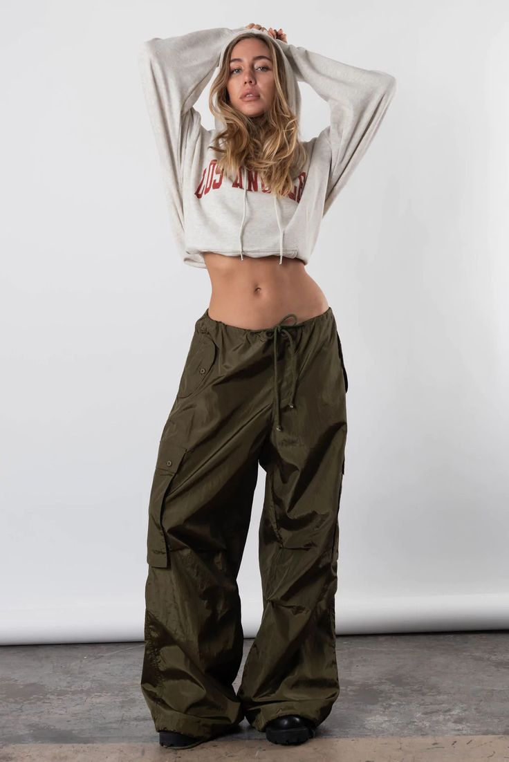 Take Us Back Parachute Pant In Olive Green – Resurrection Parachute Pants Photoshoot, Loosely Fitted Parachute Pants With Cargo Pockets, Sporty Spring Cargo Pants With Drawstring, Sporty Spring Cargo Pants With Functional Drawstring, Olive Green Parachute Pants Outfit, Sporty Relaxed Fit Parachute Pants For Fall, Relaxed Fit Parachute Pants With Cargo Pockets, 90s Cargo Style Bottoms For Fall, Loosely Fitted Cargo Parachute Pants For Spring