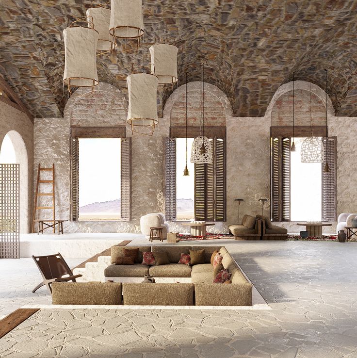 a large living room with stone walls and ceiling, couches and chairs in the middle