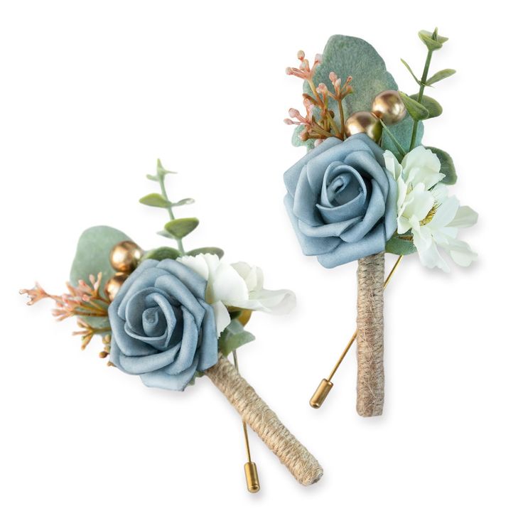 two boutonnieres with blue flowers and greenery