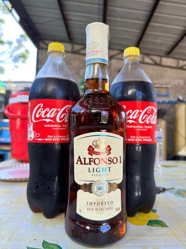 two bottles of alcohol sitting on top of a table