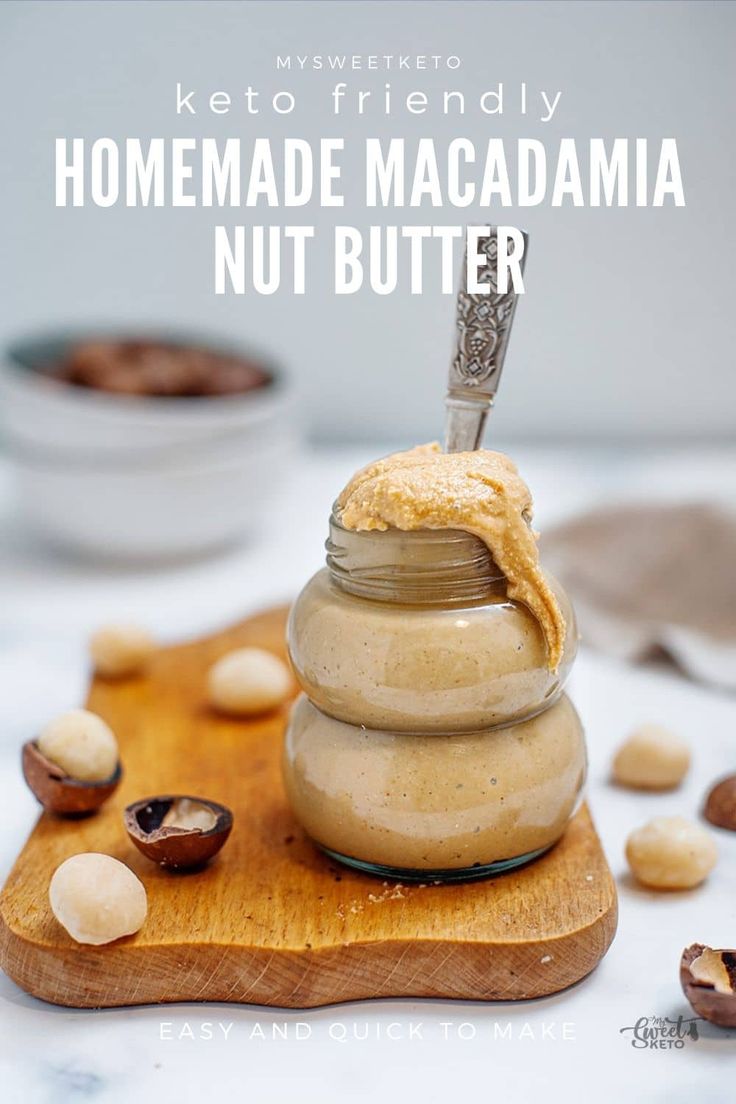 homemade macadama nut butter in a glass jar on a cutting board with nuts