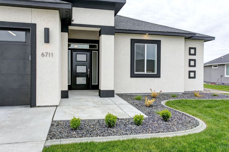 a house with black and white trim on the front door is shown in this image