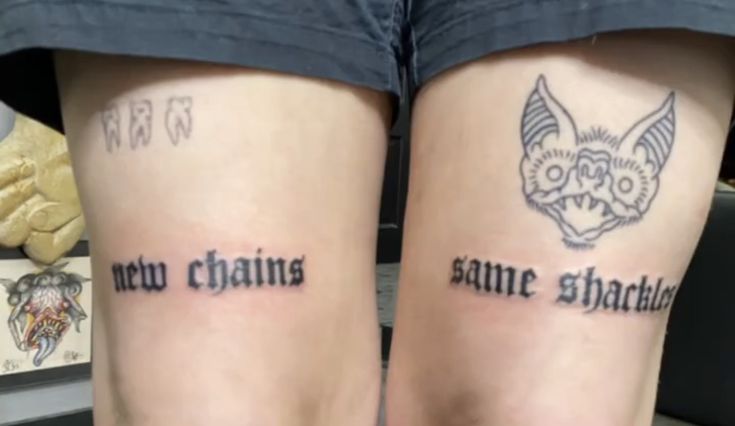 two people with tattoos on their legs that say new chains and same shatchup