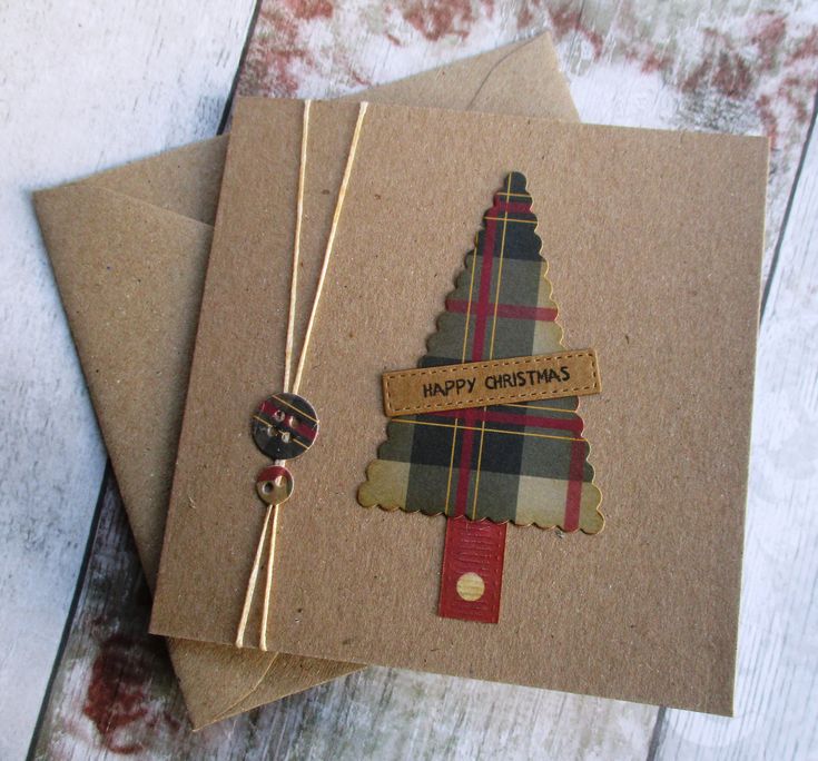 two christmas cards on top of each other with a ribbon and tag attached to them