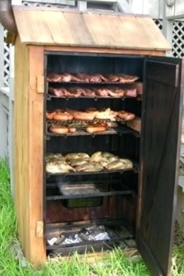 an old fashioned wooden cabinet filled with lots of bread and pastries in the grass