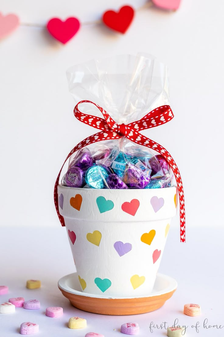 a cup filled with candy sitting on top of a table