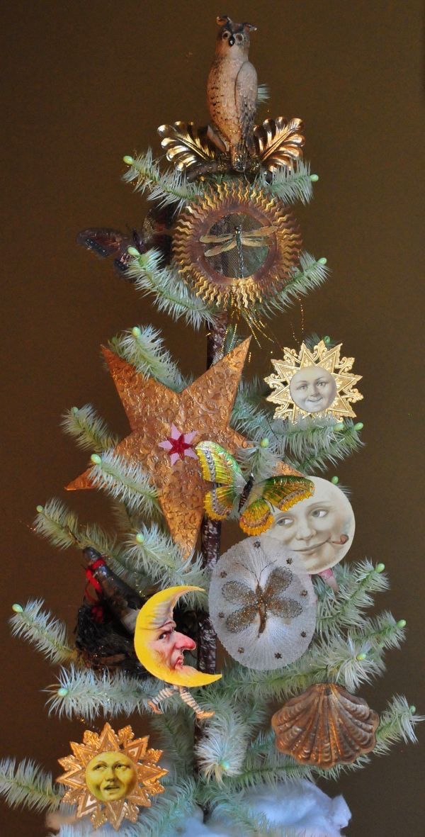 a small christmas tree decorated with seashells and starfish