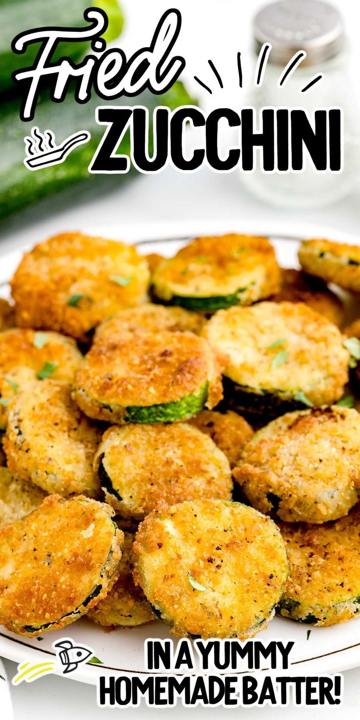 fried zucchini on a white plate next to cucumbers