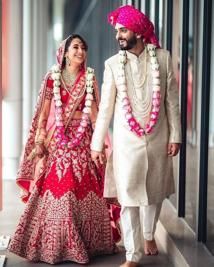 Jaimala Ideas Perfect For Your Intimate Wedding! | WedMeGood Indian Wedding Garland, Wedding Outfits For Groom, Indian Groom Wear, Wedding Dresses Men Indian, Flower Garland Wedding, Groom Wedding Dress, Wedding Lehenga Designs, Bride Photography Poses, Bride And Groom Outfit