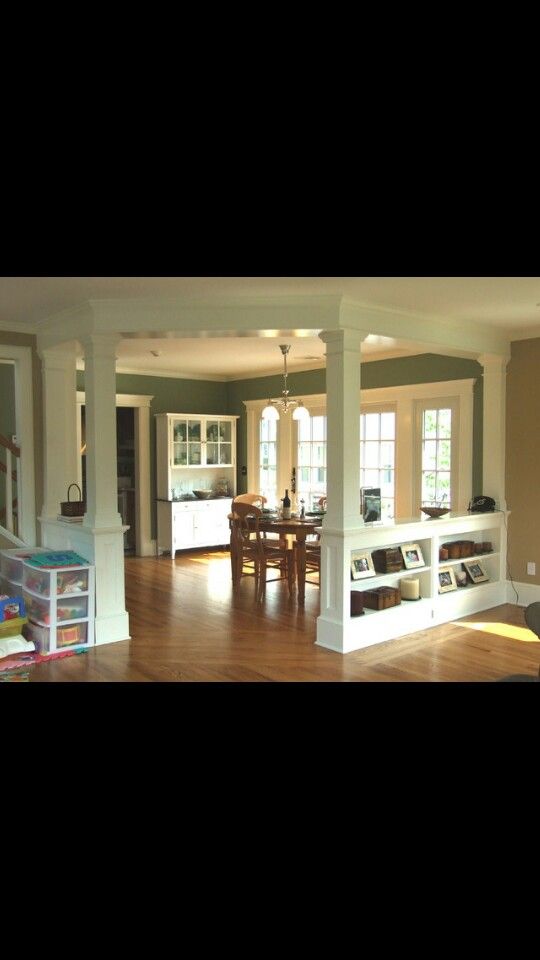 a living room and dining area with hard wood flooring in an open concept home