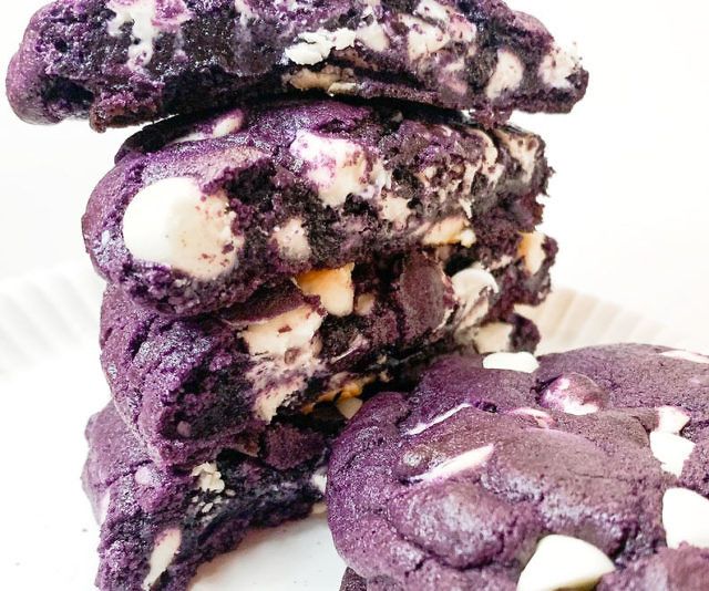 three cookies are stacked on top of each other with white chocolate chips and marshmallows