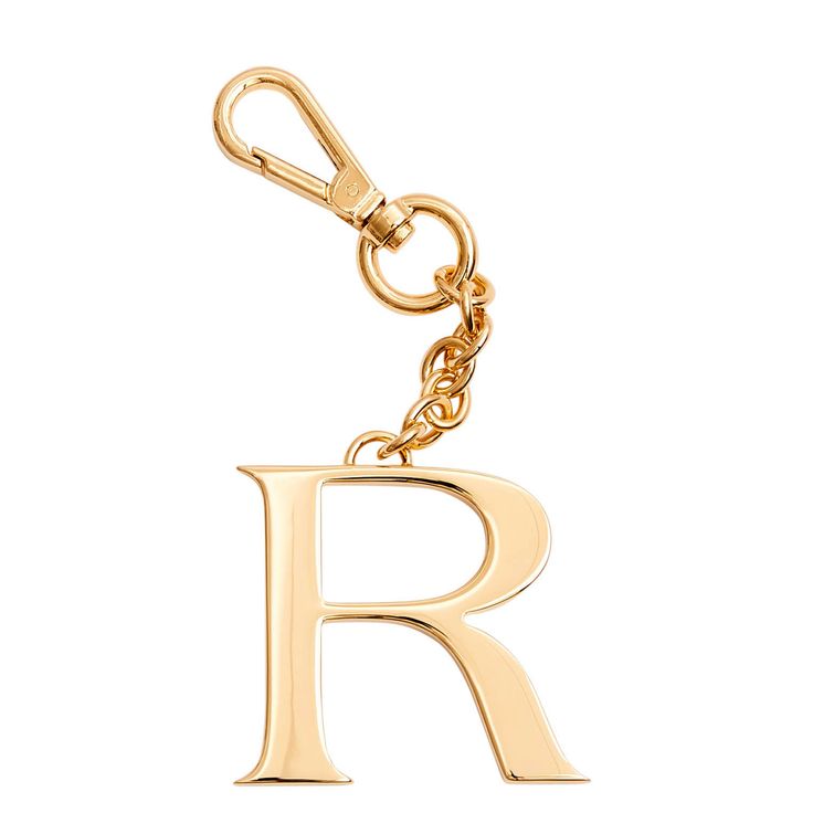 a gold metal key chain with the letter r on it's front and back ends