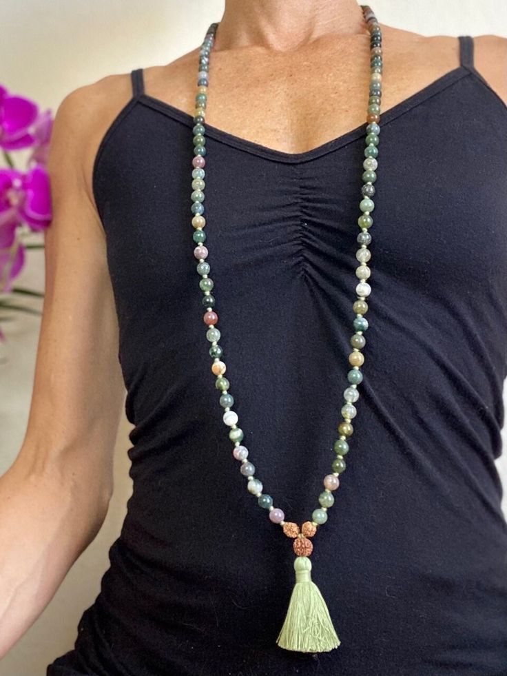 This green (and some blue-ish) moss agate mala bead necklace has the traditional 108 8mm beads, dipped in the holy river Ganges for spiritual potency! Moss agate is said to encourage tranquility and emotional balance. Moss agate is the perfect stone for those who experience strong aggression or overly nurturing emotions, helping to balance male and female energies whenever they become too extreme. Moss Agate is a stone of new beginnings. Refreshes the soul and enables you to see beauty in all you behold. Moss Agate reduces sensitivity to weather and environmental pollutants. It attracts abundance in wealth and improves self-esteem. Green Mala With 8mm Beads For Healing, Green Gemstone Beads Mala For Healing, Spiritual Jade Beaded Necklaces For Meditation, Green Hand-strung Spiritual Mala, Green Spiritual Mala With 108 Beads, Agate Gemstone Beads Mala For Healing, Bohemian Moss Agate Necklaces For Meditation, Green Beaded Mala For Healing, Healing Agate Mala With Gemstone Beads