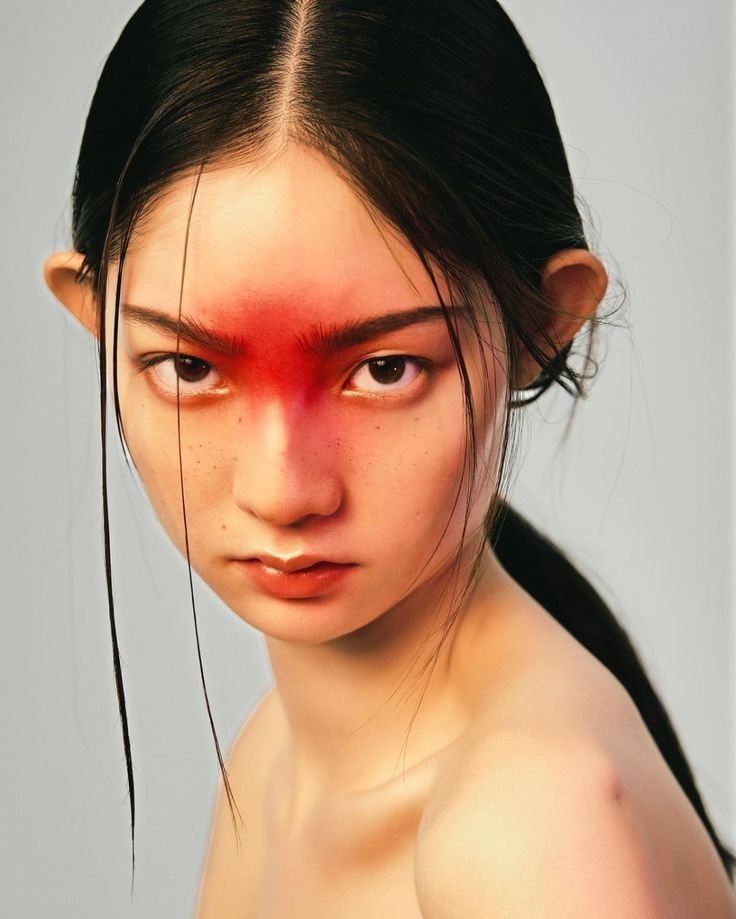 a woman with red paint on her face