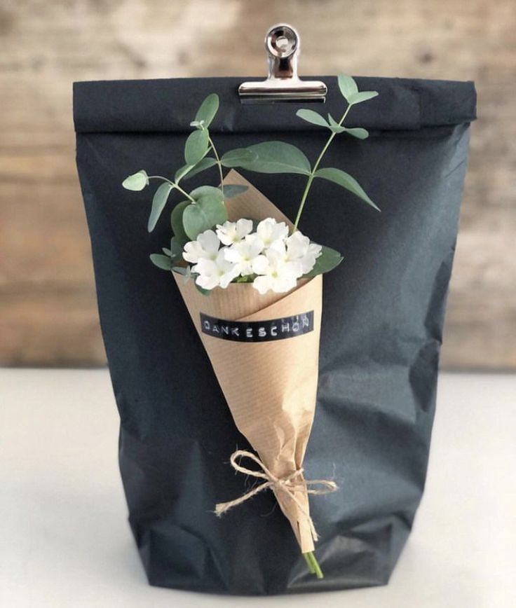 a bag with some flowers in it sitting on a table