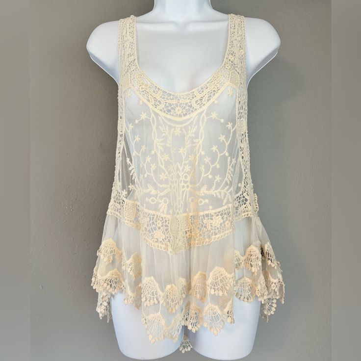 Size M/L. Sheer Off White/Cream Pol Tank Top. Cute Lace/Crocheted Detail. Never Worn. Pit To Pit: Approximately 19 Inches Pit To Bottom: Approximately 27 Inches Summer Beige Tops With Delicate Lace, Summer Cream Crochet Top With Lace Trim, Cream Lace Tops With Crochet Trim, Summer Beige Delicate Lace Top, Beige Delicate Lace Summer Tops, Beige Festival Tops With Lace Trim, Summer Cream Crochet Top With Lace Patchwork, Cream Crochet Top With Lace Patchwork For Summer, Summer Beige Lace Work Tops