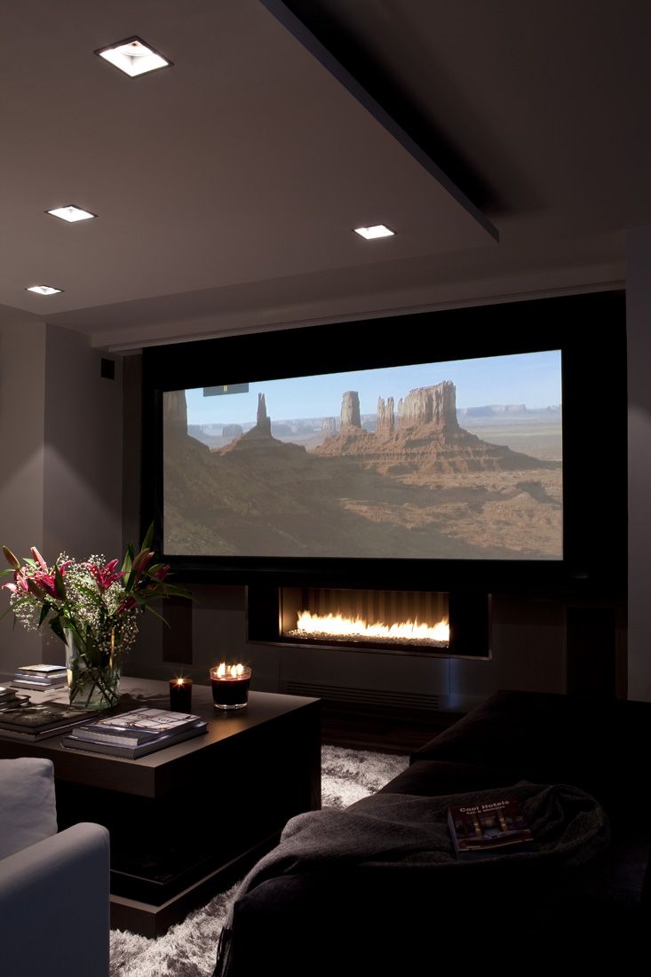 a living room filled with furniture and a flat screen tv mounted to the side of a wall