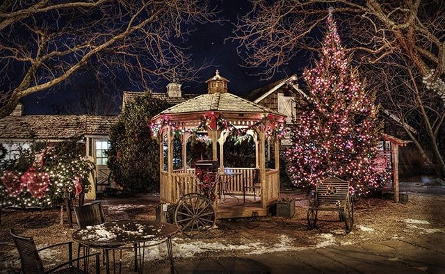 a gazebo surrounded by christmas trees and decorations