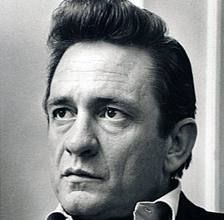 a black and white photo of a man in a suit looking off to the side