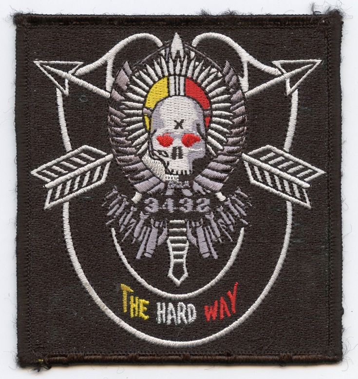 an embroidered patch with a skull and arrows on the front, says the hard way