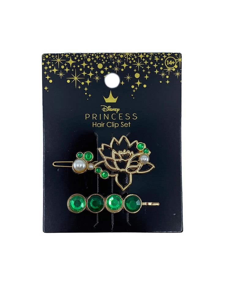 the princess hair clip set has green stones and pearls on each side, along with a flower