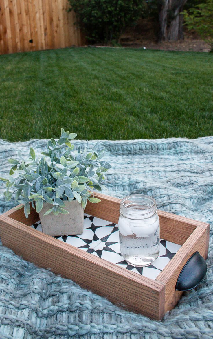 a small potted plant sitting on top of a wooden tray