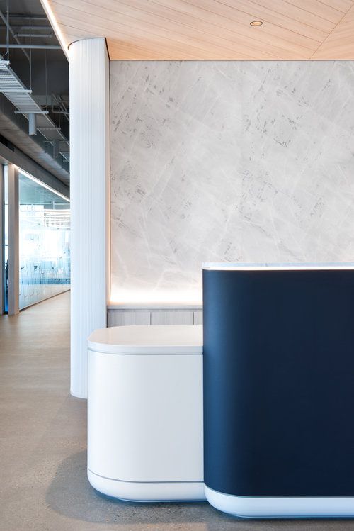 two white and blue curved tables in an office