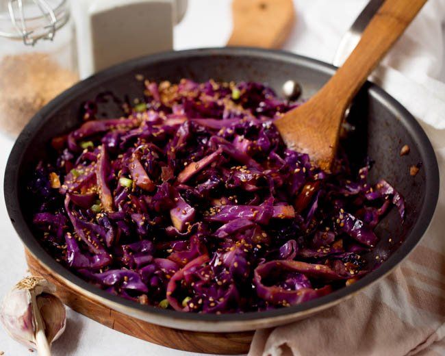 a pan filled with red cabbage on top of a table