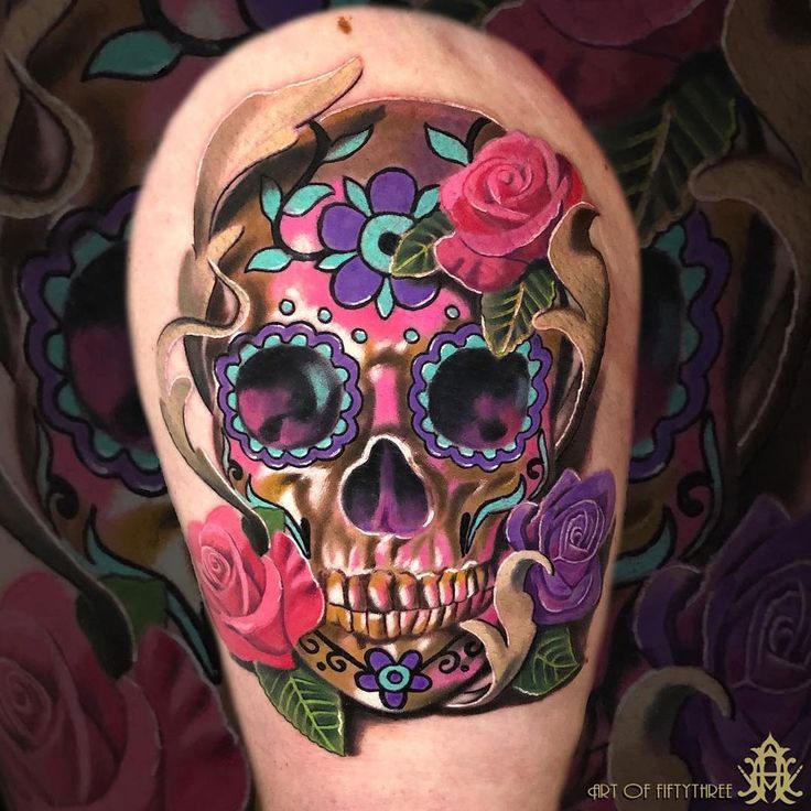 a colorful skull with roses on it's side