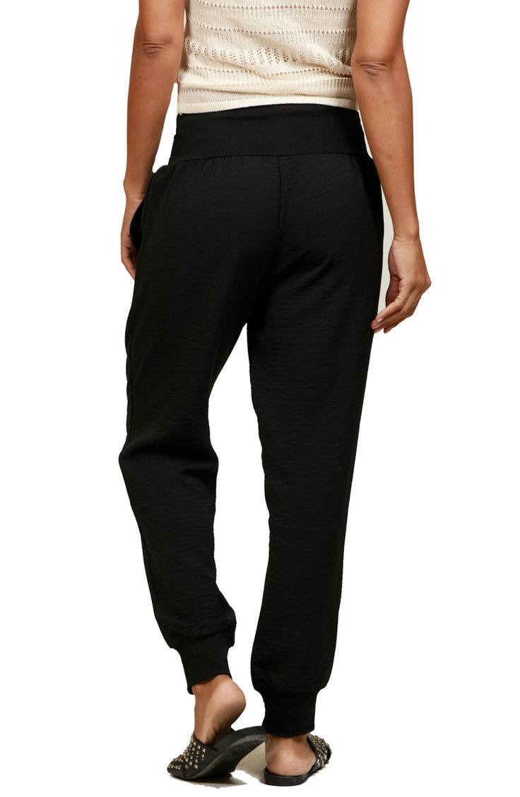 A wide waistband and notched cuffs provide a comfy fit in relaxed joggers featuring convenient side pockets. 28" inseam; 8" leg opening; 10 1/2" front rise; 14 1/2" back rise (size S) 100% polyester Dry clean Made in the USA Sporty Joggers With Cuffed Ankles, Black Athleisure Bottoms With Pull-on Style, Sportswear Joggers With Tapered Leg And Elastic Waistband, Athleisure Straight Leg Bottoms With Ribbed Cuffs, Athleisure Stretch Joggers With Cuffed Ankles, Straight Leg Joggers With Ribbed Waistband For Jogging, Athleisure Straight Leg Joggers With Ribbed Waistband, Sporty Black Pull-on Sweatpants, Black Sporty Pull-on Sweatpants