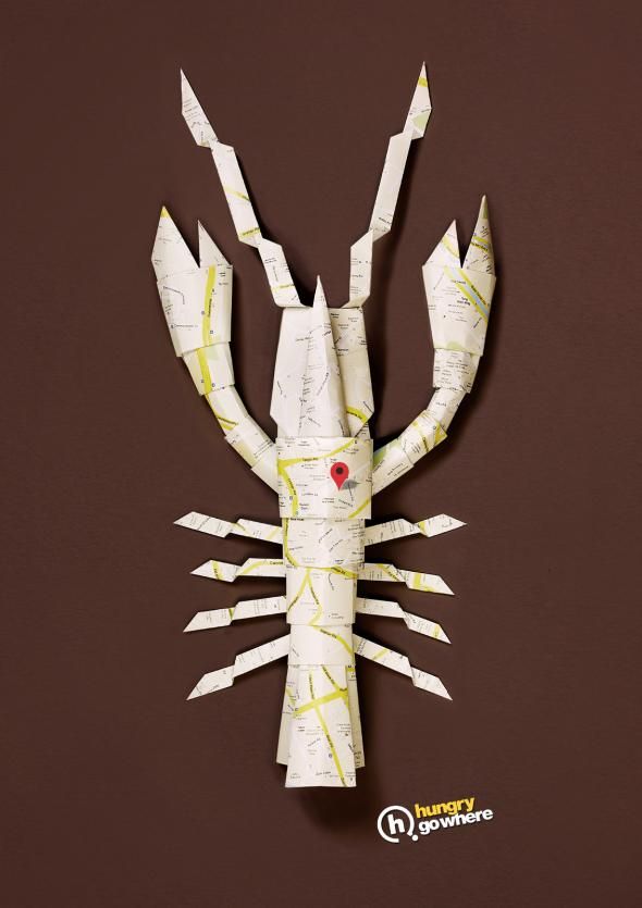 a crab made out of paper on a brown background