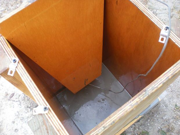 an open wooden box sitting on the ground