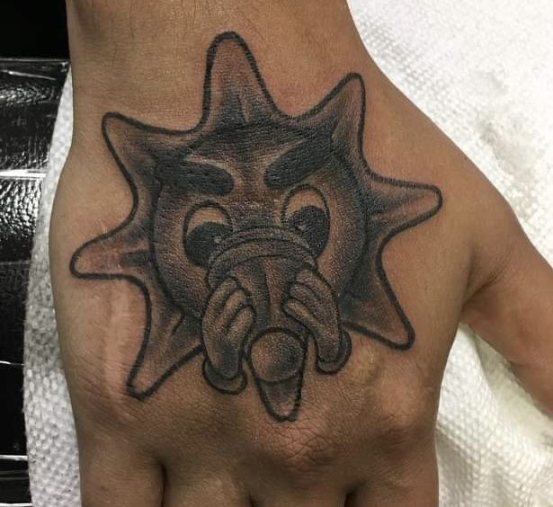 a hand with a black and white tattoo design on it's left palm, which has an elephant head in the middle