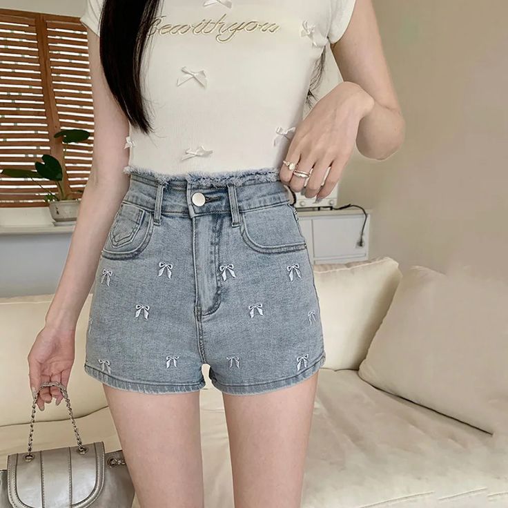 Add a touch of girly charm to your summer wardrobe with our Pretty Bow Embroidered Jean Shorts 🎀. The distressed waist and bow embroidery add a unique and cute factor to these shorts, available in four charming colors. Stay stylish and comfortable all season long. Size Chart: Size Waist (cm) Hip (cm) Length (cm) Waist (in) Hip (in) Length (in) S 60 84 30 23.62 33.07 11.81 M 64 88 31 25.20 34.65 12.20 L 68 92 32 26.77 36.22 12.60 XL 72 96 33 28.35 37.80 12.99 Description: Item Type: ShortsDecoration: Bow/Button/Embroidery/Pockets/Zipper Fabric Type: DenimPattern Type: BowsFit Type: RegularMaterial: PolyesterOrigin: CNWaist Type: HighClosure Type: Zipper Fly Cute High-waisted Shorts For Spring, Cute Short-length Bottoms For Spring, Cute Short Length Bottoms For Spring, Cotton Above Knee Shorts For Spring, Trendy Above Knee Shorts For Spring, Trendy Above Knee Spring Shorts, Cute Jean Shorts For Spring, Cute Summer Jean Shorts, Embroidered Jean Shorts