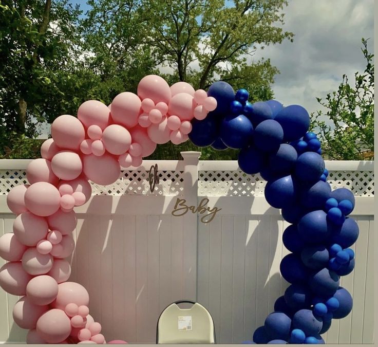 a balloon arch with blue and pink balloons